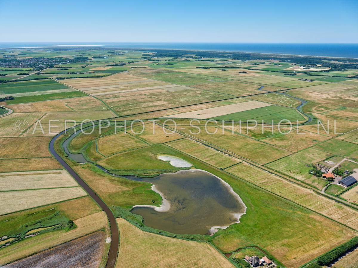 luchtfoto |  Texel, de Westerkolk, Polder Waal en Burg was vroeger een kweldergebied, in het huidige  landschap ligt  een oude kreek, deze kreek vind zijn oorsprong in de Westerkolk die is ontstaan bij een doorbraak van de Ruigendijk (Ruige Dijk).
 | 01/07/2018